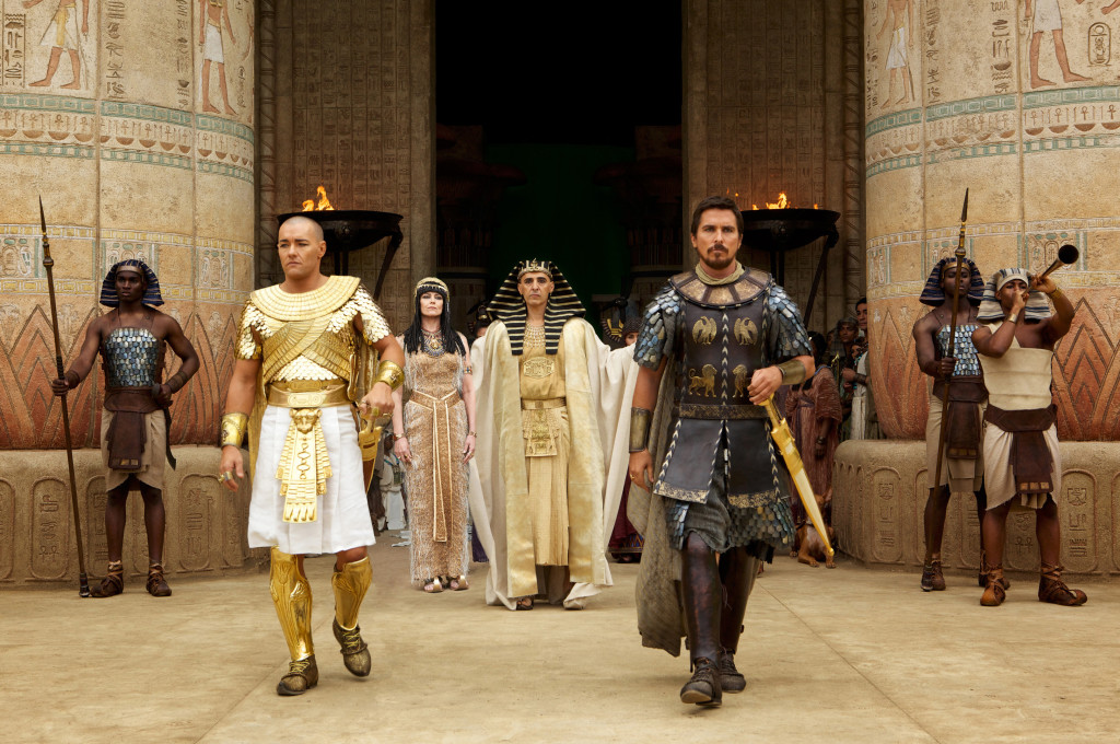 DF-00727R - Seti (John Turturro, background) presents the future leaders of Egypt: Ramses (Joel Edgerton, left) and Moses (Christian Bale).